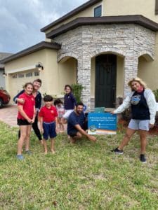 Principal, Teachers Deliver Honor Roll Signs to Students