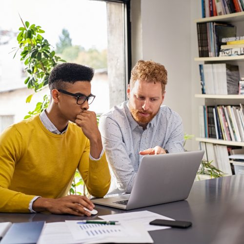 Creative business people working on laptop